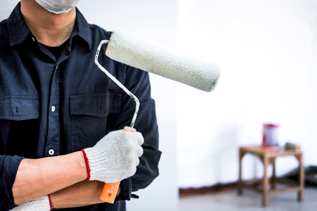 vecteezy male painter holding paint roller in newly painted white room 1236434